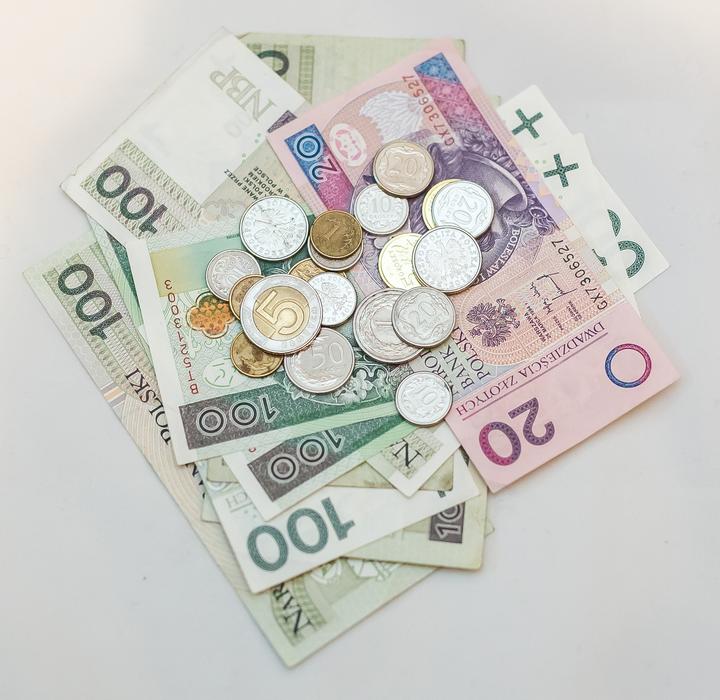 paper money and coins on white background