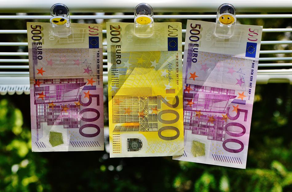 three Euro Bills hanging on grill