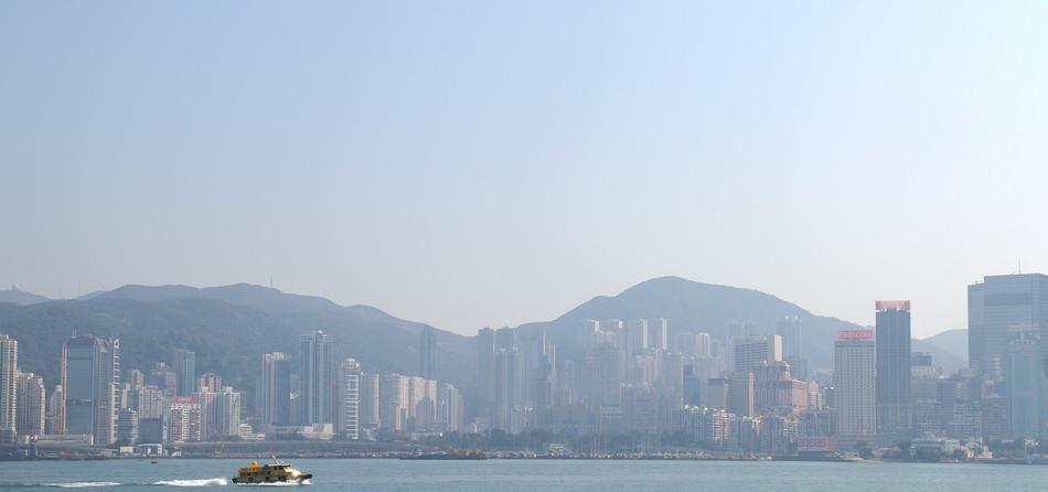 Beautiful skyline of Hong Kong with the shore and mountains