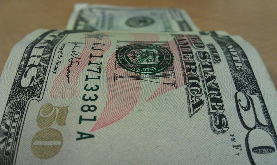 50 dollar bill on blurred background