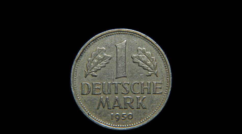 old german coin on black background