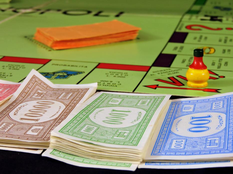 Colorful and beautiful 'Monopoly' board game with figures, cards and banknotes