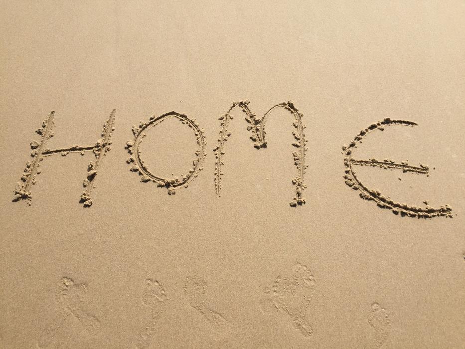 the inscription home on the sand