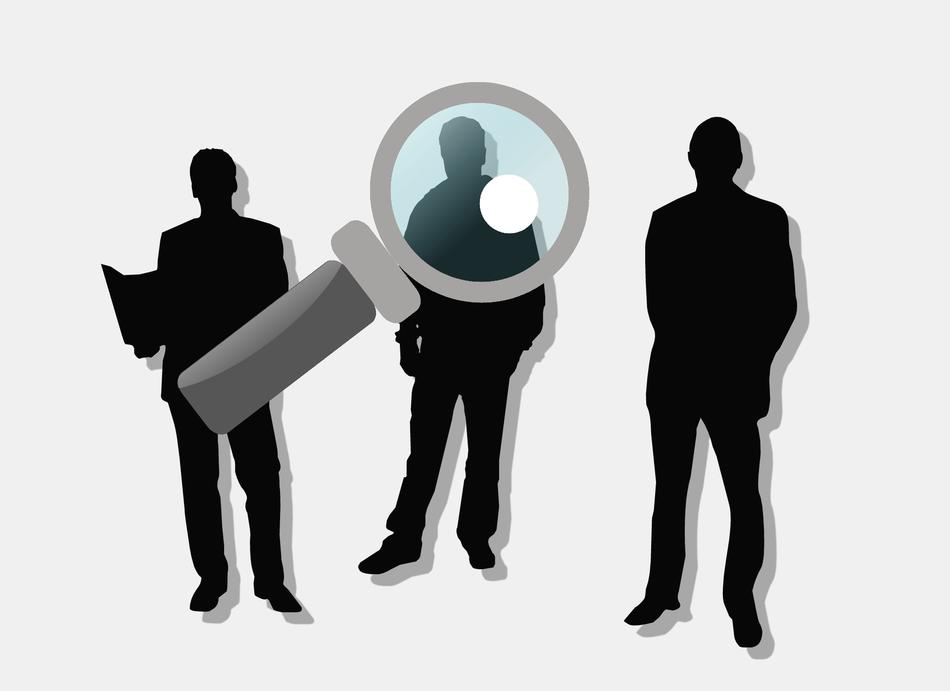 magnifying glass on silhouettes of people