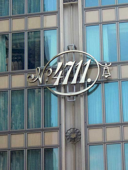 Beautiful, shiny '4711' sing on the facade of the building with windows