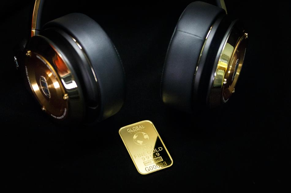 golden earphones and gold bar
