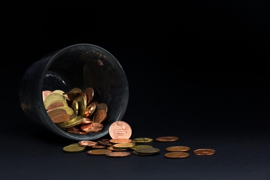 coins in an inverted glass as a concept