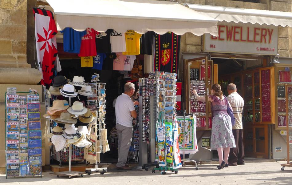 People, near the store with colorful stuff on Gozo, Malta