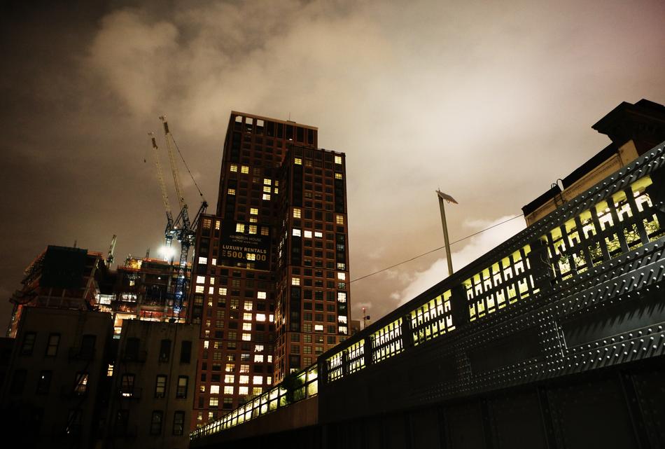 Cityscape of the construction site with lights, in the evening