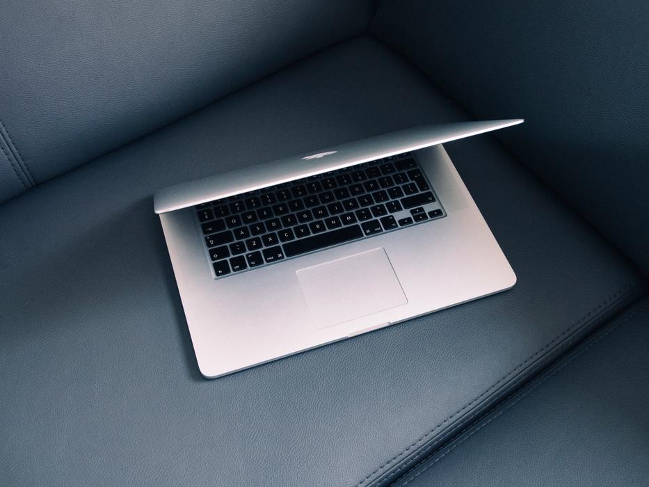 white laptop on the couch