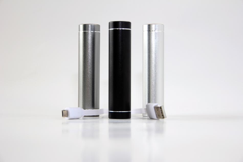 Close-up of the shiny battery chargers of different colors, with cabels