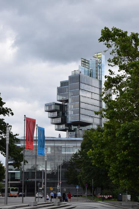 Cityscape with the buildings among the plants, in Hannover, Germany, under the clouds
