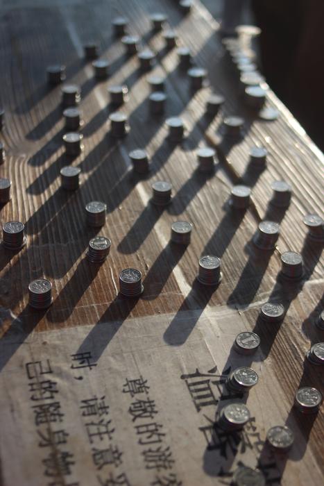 Shiny coins with the shadows, in light, on the surface with hieroglyphs