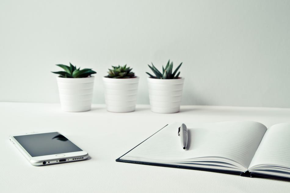 Desk Smartphone amd note and flowers pot
