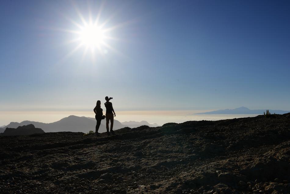 silhouettes of couples in the bright sun in the canary islands