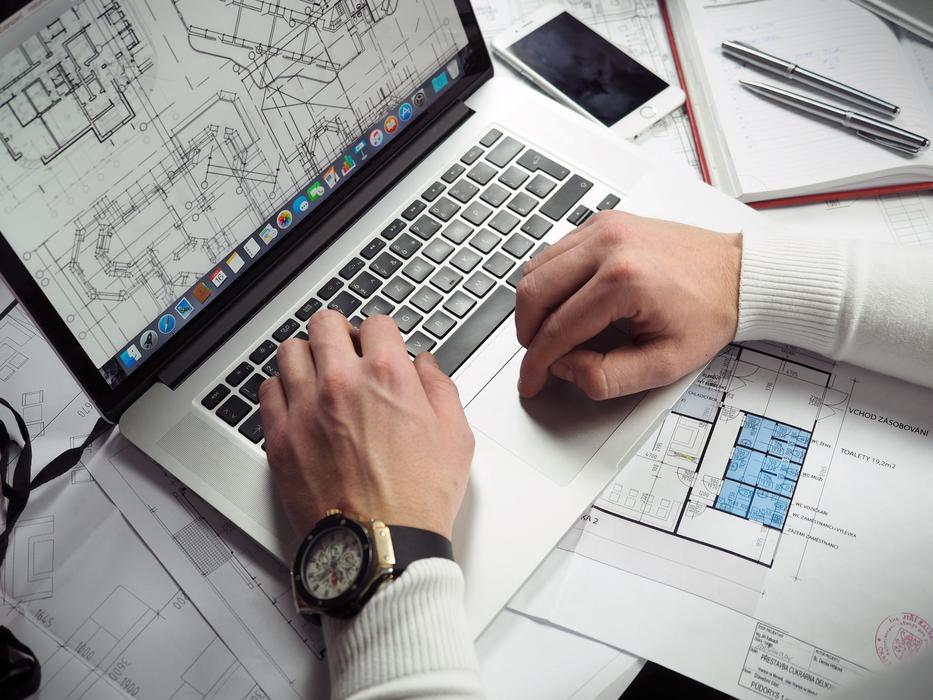 male hands on laptop with drawings on screen