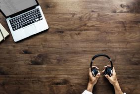 earphones and laptop on the wooden table