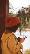 Young Girl in red Hat looking at smartphone