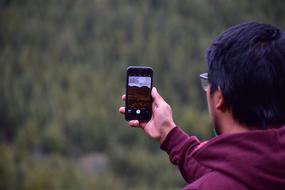 guy with a mobile phone in his hand on a blurred background