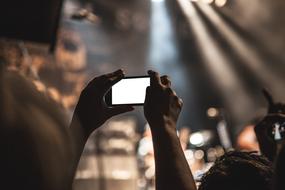 Smartphone taking a picture on a concert