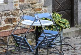 chairs leaning on table in open air Cafe