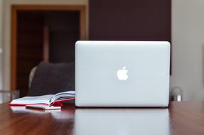 laptop, red diary and smartphone on the table