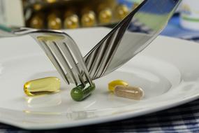 cut pills with a knife and fork