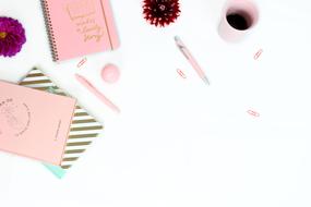 Feminine background with pink notebooks and copy space