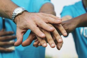 hands of different race people together
