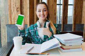 girl at work desk with green screen phone