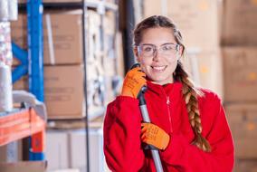 girl cleans up in an industrial warehouse