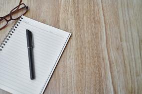 Black Pen on blank notepad