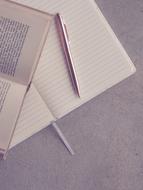 open book and pen on blank notebook
