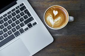 Laptop and coffe on a wooden table