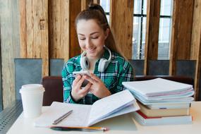 photo of happy student looking at smartphone