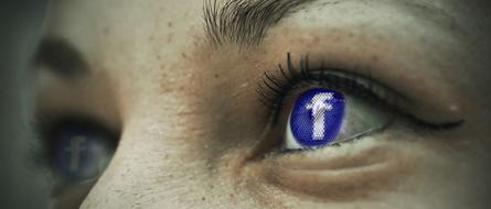 Facebook icon reflection in the woman's eyes