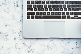 laptop keyboard on marble table