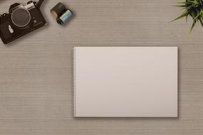 Camera and empty Notebook on desk