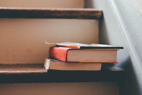 books on old stairs close up