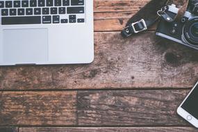 grunge wooden Background with Camera and Computer