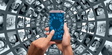 smartphone in hands on the background of the world wide web