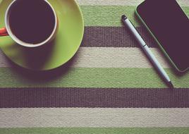 cup of coffee and a phone in a creative office