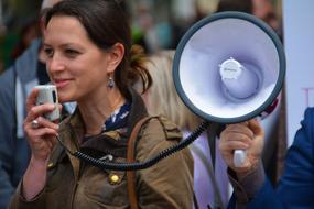 girl speaks loudly through a megaphone