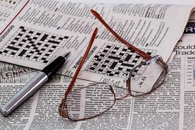 glasses and a pen on newspapers