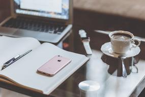 Apple gadgets and coffee on desk