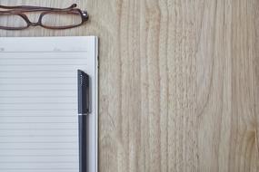 blank sheet, pen and glasses on the table