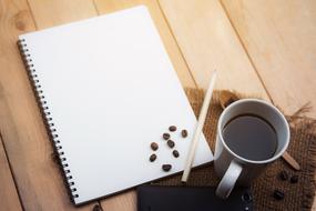 wooden Desk and notebook with Coffee in home
