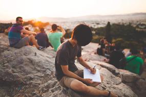 group of people is doing sketches on the beach