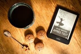 black coffee with cookies and book