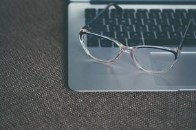 glasses on gray laptop